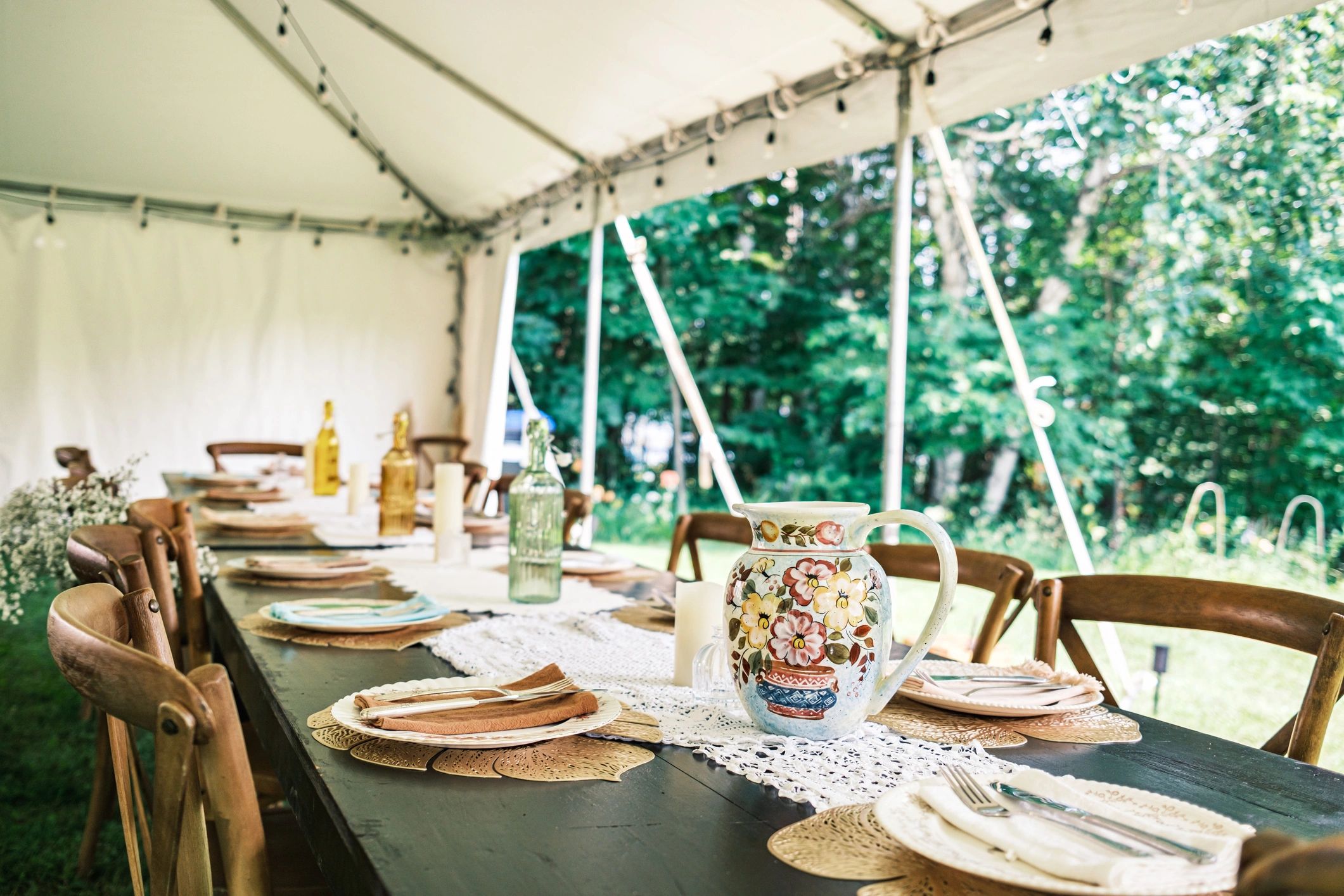Elegant table setting decor inside a wedding tent